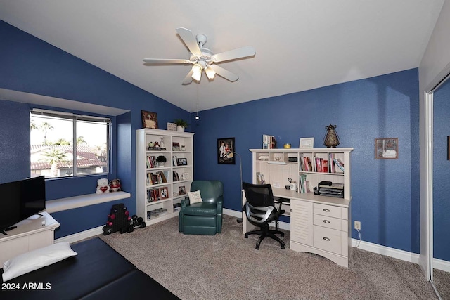 carpeted office space featuring lofted ceiling and ceiling fan