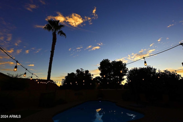 view of pool at dusk