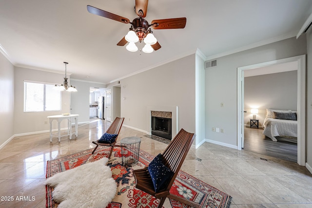 living room featuring baseboards, visible vents, a fireplace with flush hearth, and ornamental molding