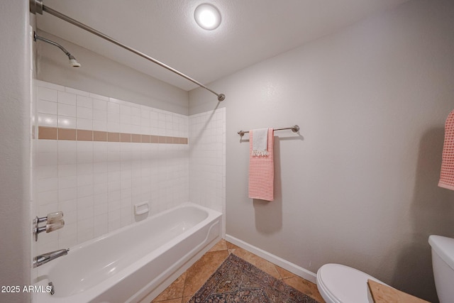 bathroom with toilet, baseboards, shower / washtub combination, and tile patterned floors