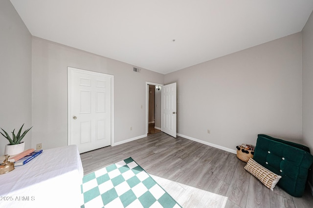 unfurnished bedroom featuring light wood-type flooring, visible vents, and baseboards