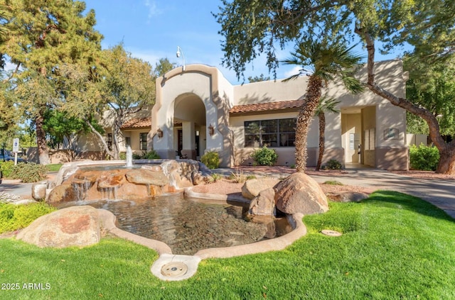 view of front of home with a tile roof and stucco siding