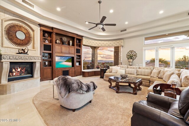 6621 N Arizona Biltmore Cir, Phoenix, AZ 85016 - living room featuring recessed lighting, a ceiling fan, a glass covered fireplace, and a tray ceiling
