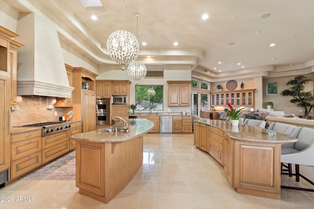 6621 N Arizona Biltmore Cir, Phoenix, AZ 85016 - kitchen featuring a large island, stainless steel appliances, a tray ceiling, a breakfast bar, and a sink