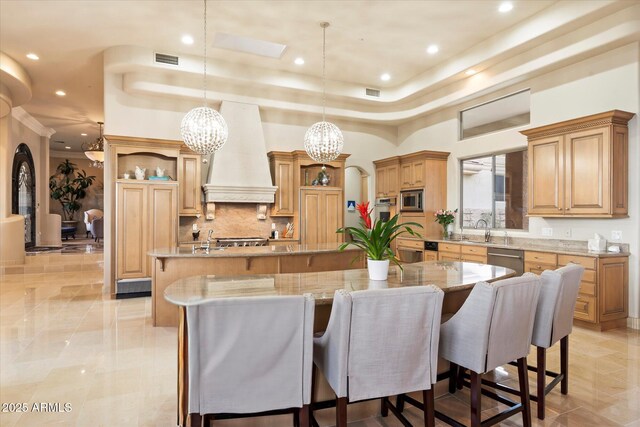6621 N Arizona Biltmore Cir, Phoenix, AZ 85016 - kitchen with a large island with sink, open shelves, stainless steel appliances, premium range hood, and a chandelier