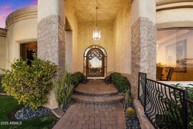 6621 N Arizona Biltmore Cir, Phoenix, AZ 85016 - exterior entry at dusk with stucco siding and a porch