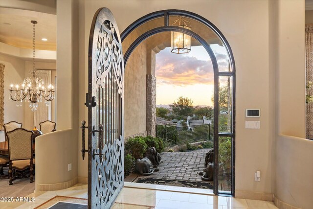 6621 N Arizona Biltmore Cir, Phoenix, AZ 85016 - doorway featuring a chandelier, baseboards, and recessed lighting