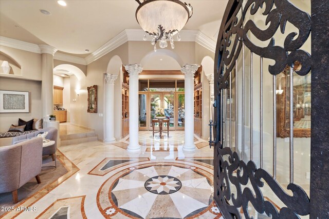 6621 N Arizona Biltmore Cir, Phoenix, AZ 85016 - foyer entrance with decorative columns, inlaid floor details, arched walkways, marble tiled floors, and ornamental molding