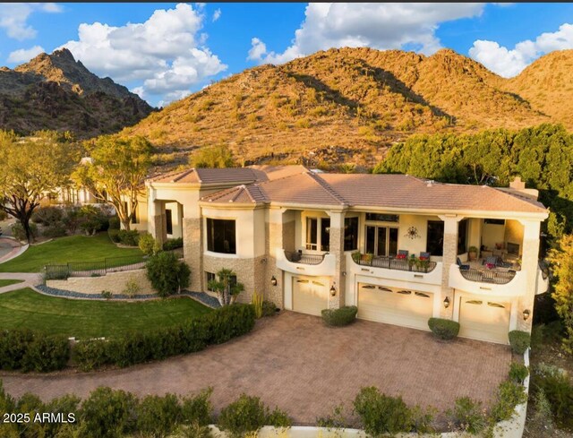 6621 N Arizona Biltmore Cir, Phoenix, AZ 85016 - mediterranean / spanish-style home featuring a mountain view, driveway, a balcony, an attached garage, and a tiled roof