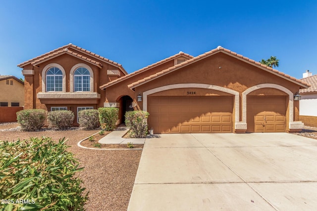 3424 E Harmony Ave, Mesa, AZ 85204 - mediterranean / spanish-style home with an attached garage, concrete driveway, stucco siding, and a tile roof