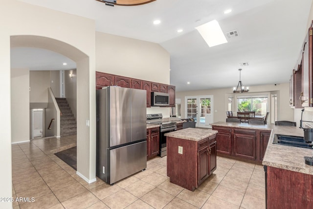 3424 E Harmony Ave, Mesa, AZ 85204 - kitchen featuring appliances with stainless steel finishes, light countertops, light tile patterned floors, hanging light fixtures, and lofted ceiling