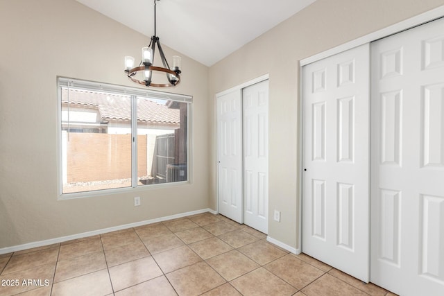 3424 E Harmony Ave, Mesa, AZ 85204 - unfurnished dining area with a chandelier, lofted ceiling, light tile patterned floors, and baseboards