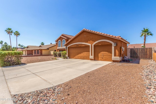 3424 E Harmony Ave, Mesa, AZ 85204 - mediterranean / spanish-style house featuring an attached garage, concrete driveway, stucco siding, and a tile roof