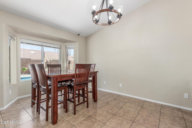 3424 E Harmony Ave, Mesa, AZ 85204 - dining space featuring a chandelier, vaulted ceiling, baseboards, and light tile patterned flooring