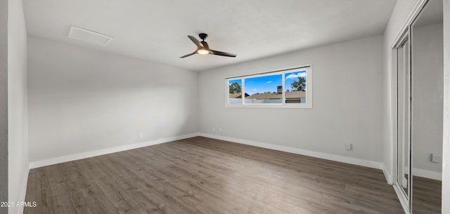 unfurnished bedroom with baseboards, ceiling fan, wood finished floors, and a closet