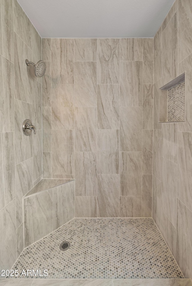 full bath with a tile shower