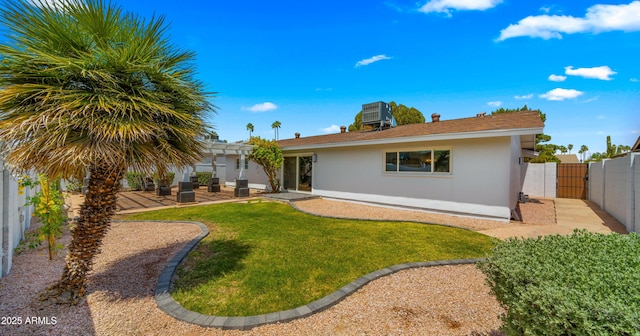 view of front of property with a front yard, a patio area, a fenced backyard, a pergola, and stucco siding