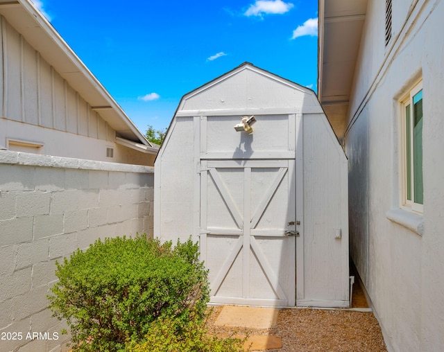 view of shed with fence