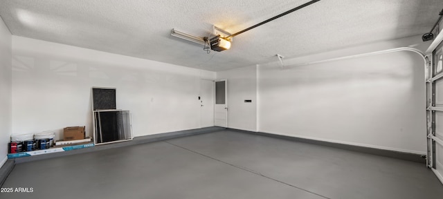 garage with baseboards and a garage door opener