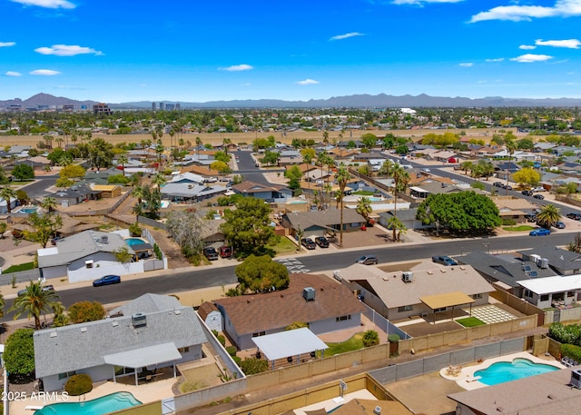 birds eye view of property with a mountain view and a residential view