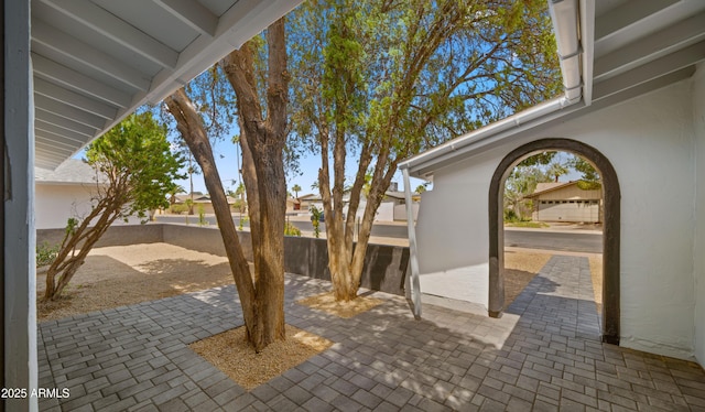 view of patio featuring fence and a residential view