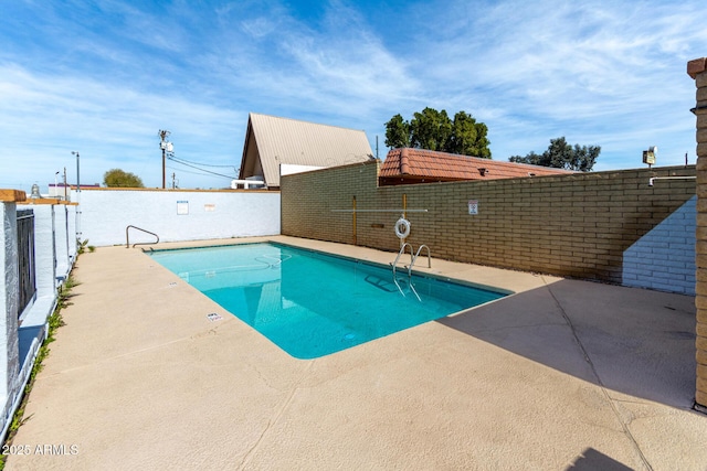 view of swimming pool featuring a fenced in pool, a fenced backyard, and a patio