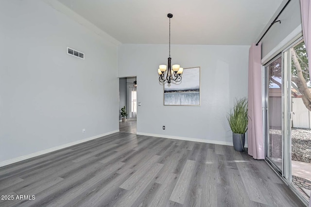 unfurnished dining area with a chandelier and hardwood / wood-style floors