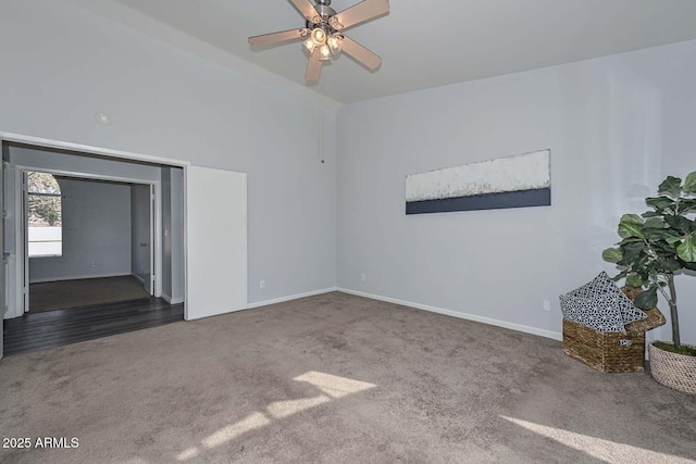 unfurnished room with dark colored carpet and ceiling fan