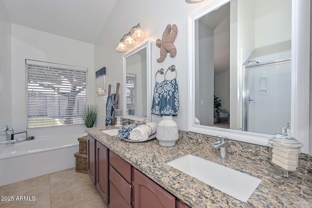 bathroom featuring separate shower and tub, tile patterned flooring, lofted ceiling, and vanity