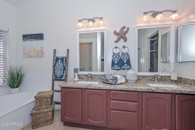 bathroom featuring tile patterned flooring, a bath, and vanity