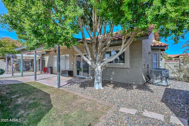 back of house featuring a patio, a pergola, and central AC