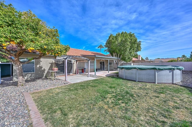 view of yard featuring a covered pool, a patio, and a pergola