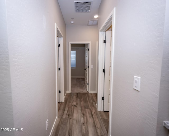 corridor with light hardwood / wood-style floors