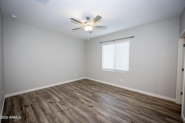 empty room featuring hardwood / wood-style flooring and ceiling fan