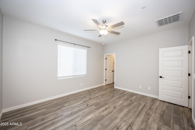 spare room with ceiling fan and light hardwood / wood-style floors