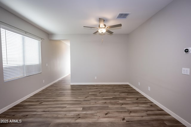 unfurnished room featuring dark hardwood / wood-style flooring and ceiling fan