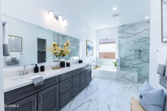 bathroom with tile floors, separate shower and tub, double sink, and large vanity