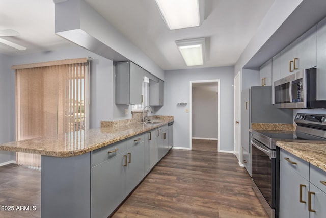 10236 N 105th Dr, Sun City, AZ 85351 - kitchen featuring stainless steel appliances, gray cabinetry, a peninsula, and baseboards