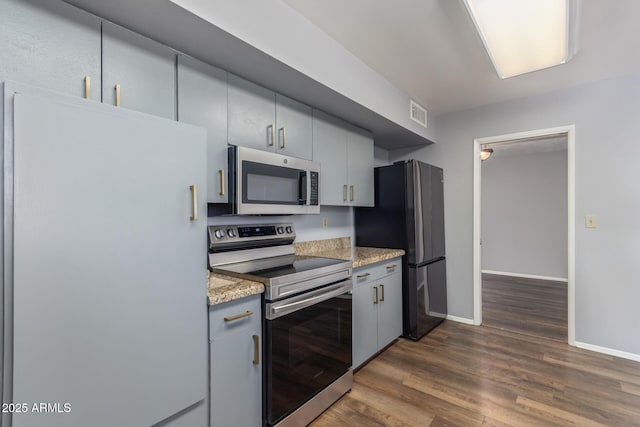10236 N 105th Dr, Sun City, AZ 85351 - kitchen featuring appliances with stainless steel finishes, baseboards, dark wood-style flooring, gray cabinets, and light stone counters