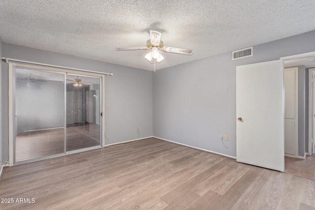 10236 N 105th Dr, Sun City, AZ 85351 - unfurnished bedroom with wood finished floors, a closet, a ceiling fan, a textured ceiling, and baseboards