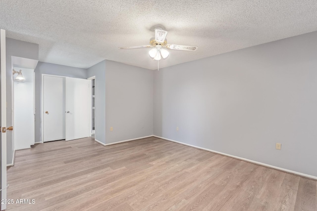 10236 N 105th Dr, Sun City, AZ 85351 - unfurnished bedroom featuring light wood finished floors, a textured ceiling, baseboards, ceiling fan, and a closet