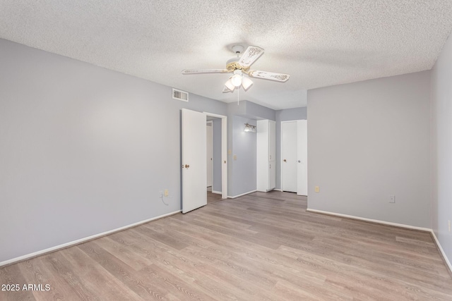 10236 N 105th Dr, Sun City, AZ 85351 - unfurnished bedroom with light wood finished floors, a textured ceiling, baseboards, and ceiling fan