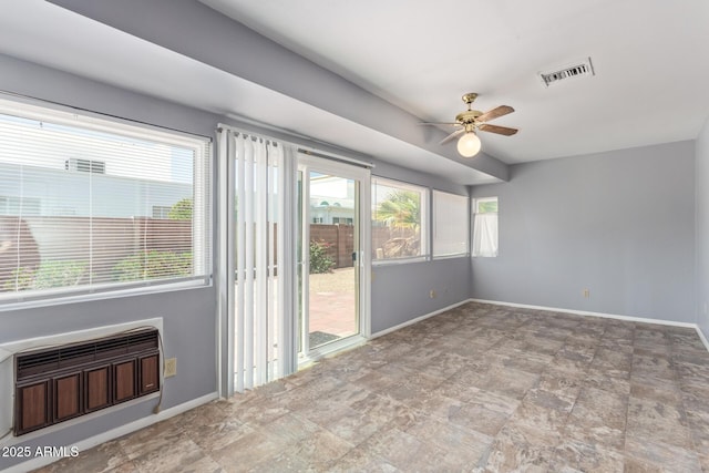 10236 N 105th Dr, Sun City, AZ 85351 - empty room with a ceiling fan, baseboards, stone finish floors, and a wall mounted AC