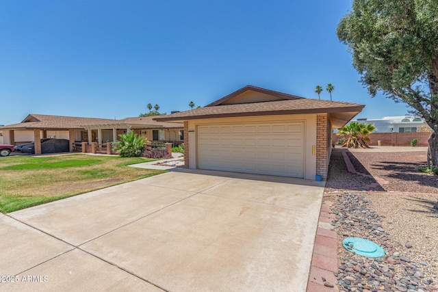 10236 N 105th Dr, Sun City, AZ 85351 - ranch-style house with driveway, an attached garage, and brick siding