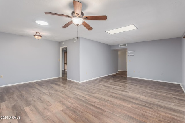 10236 N 105th Dr, Sun City, AZ 85351 - unfurnished room with ceiling fan, wood finished floors, and baseboards