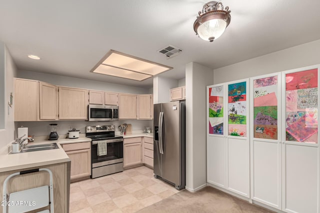 kitchen featuring a sink, light brown cabinets, visible vents, and stainless steel appliances