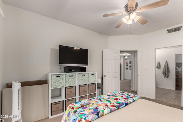 tiled bedroom featuring visible vents and ceiling fan