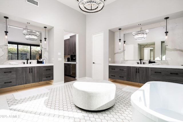 bathroom featuring a sink, visible vents, and an inviting chandelier