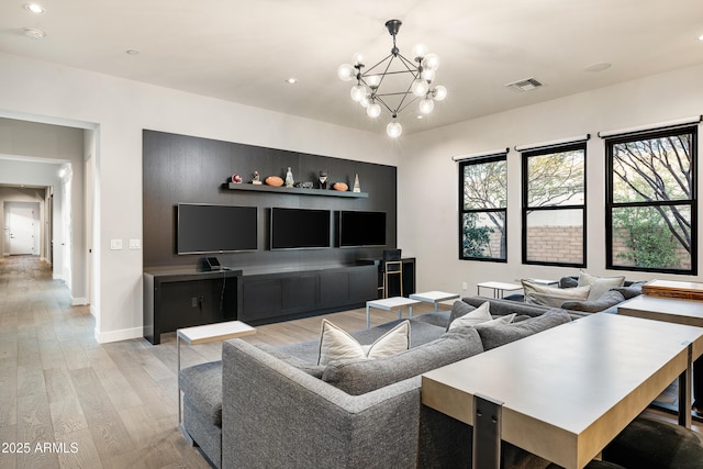 living room featuring visible vents, recessed lighting, light wood-style floors, an inviting chandelier, and baseboards