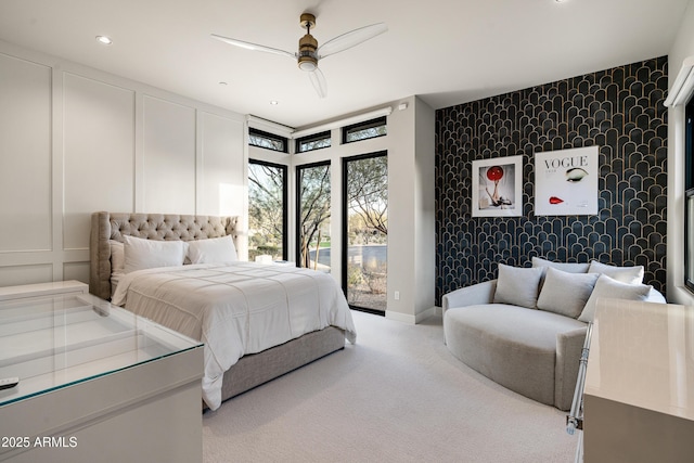 carpeted bedroom featuring an accent wall, access to exterior, a decorative wall, and wallpapered walls